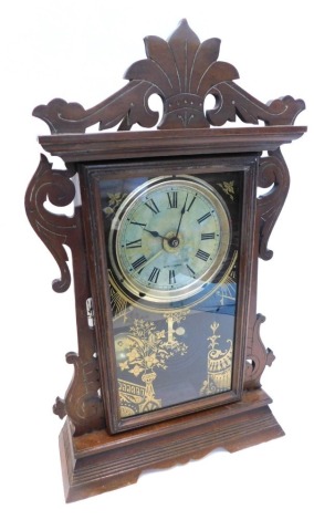 A late 19thC American mantel clock, by Seth Thomas of Thomaston Connecticut, in walnut case, decorated with scrolls, etc., eight day movement, etc., 55cm high.