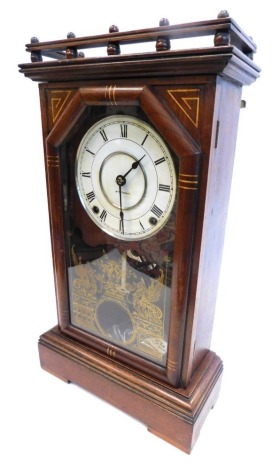 A late 19thC mantel clock, in walnut and parcel gilt case, dial stamped Seth Thomas, the case with ¾ gallery, above a door with gilt verre eglomise decoration of griffins, etc., on block feet, 57cm high.