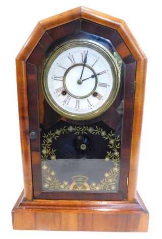 A late 19thC American mantel clock, in figured walnut case with arched top, the paper dial stamped The New Haven Clock Company USA, the door with verre eglomise decoration with flower and leaves, on a plinth, 46cm high.