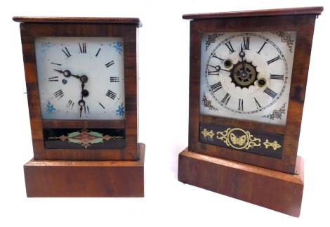 A late 19thC American mantel clock, in a mahogany case, with painted dial and alarm, the door with gilt and black verre eglomise decoration of butterfly, 30cm high, and another similar timepiece with geometric red, green and gilt detail to the verre eglom