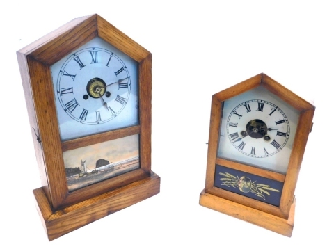 A late 19thC American Gem Cottage mantel clock, in an oak case with painted dial above an verre eglomise panel of a coastal scene, 35cm high, and a similar mantel clock with alarm labelled Rocket, 27cm high, (2).