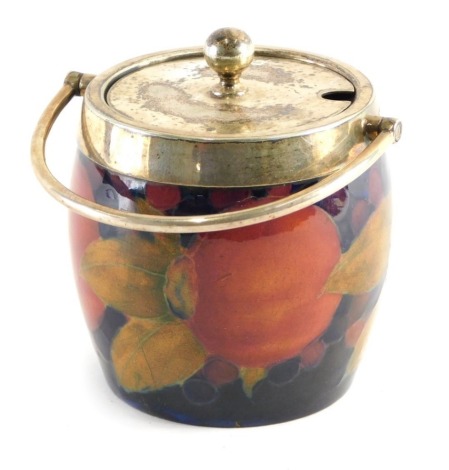 An early 20thC Moorcroft Pomegranate pattern biscuit barrel, with plated mounts and removable lid, impressed marks beneath, 9cm high.