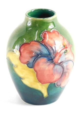 A Moorcroft pottery Anemone pattern vase, of shouldered form, on green ground, impressed marks beneath, 9cm high.