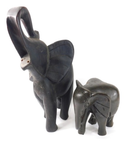 An African tribal figure of an elephant, trunk raised, 51cm high and a further figure of an elephant. (2)