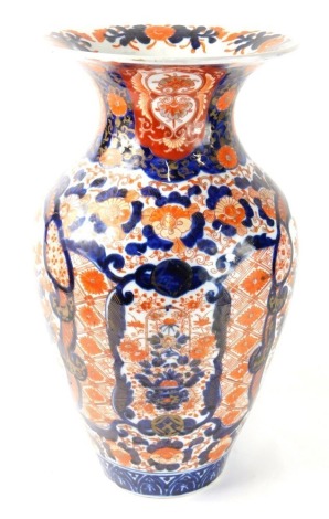 A 19thC Japanese Imari vase, with compressed trumpet stem, shouldered body, decorated with panels of flowers and birds, four character mark beneath, 45cm high.