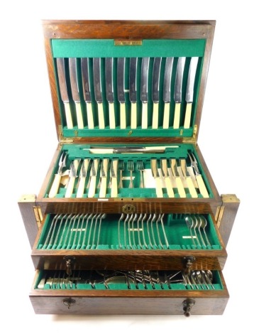 An oak cased canteen of Richardson and Binney Sheffield cutlery, with bone handled knives, Old English pattern part settings for twelve, in oak cased canteen, fronted by two drawers, flanked by quarter columns, 28cm high, 55cm wide, 37cm deep.