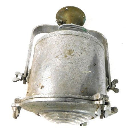 An early 20thC chrome searchlight, with domed glass in cylindrical articulated casing, on plain circular mount,47cm high.