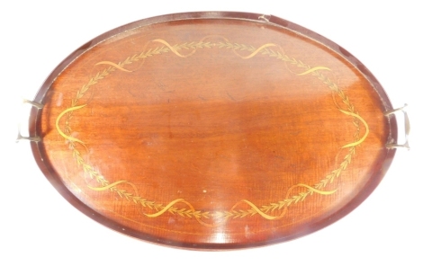 An Edwardian mahogany galleried tea tray, of oval form with curved metal handles, with a garland and scroll inlay, 69cm wide.