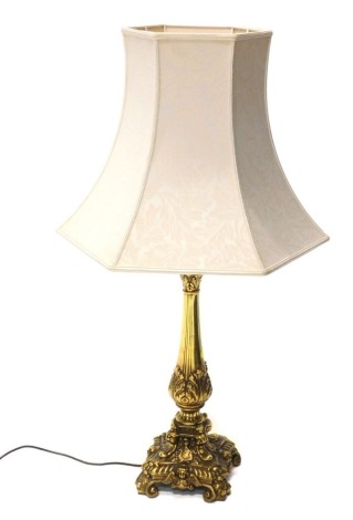 An 20thC rococo table lamp, with cream shade, and an acanthus leaf stem, on platform, terminating in scroll feet, 84cm high.