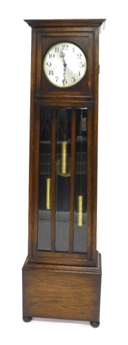 A 1920s longcase clock, the silvered dial with Arabic numerals, the case with a single door, with three bevelled glass panels, 195cm high.