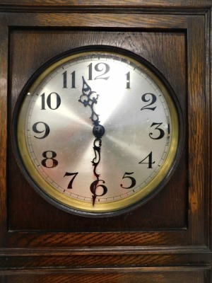 A 1920s longcase clock, the silvered dial with Arabic numerals, the case with a single door, with three bevelled glass panels, 195cm high. - 2