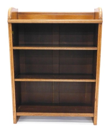 A late Victorian oak Gothic Revival open bookcase, with shaped sides and two adjustable shelves, 114cm high,84cm wide.