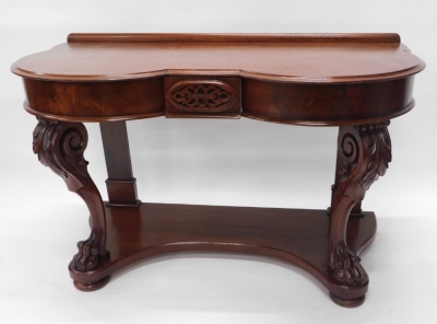 A Victorian mahogany washstand, with a short raised gallery above a double bow fronted top, with a moulded edge above a small frieze drawer, on leaf carved cabriole supports with paw feet and a concave undertier, with bun feet, 79cm high, 117cm wide.