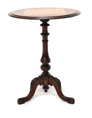 A Victorian walnut chess table, the circular inlaid top with a moulded edge, on a turned column and carved tripod base.