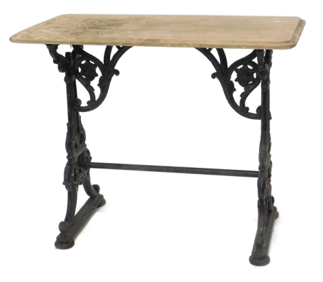 A cast iron pub or garden table, the rectangular painted wooden top on scroll cast end supports with stretcher, 74cm high, 90cm wide, 46cm deep.