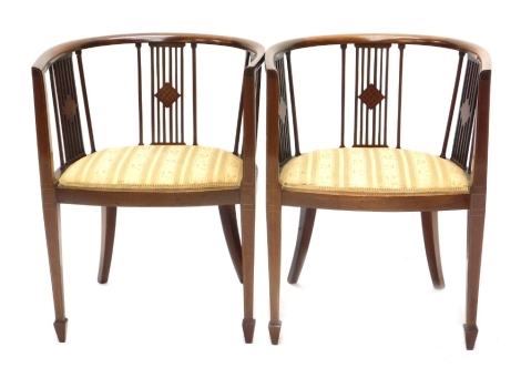 A pair of Edwardian mahogany and boxwood strung tub chairs, each with a padded seat on square tapering legs.