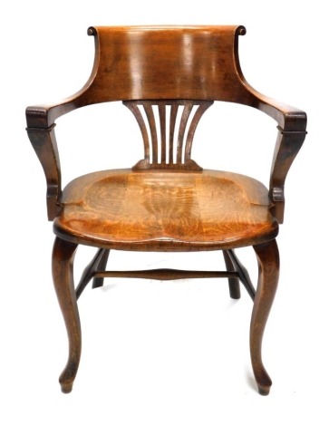 An early 20thC oak office chair, the shaped back with pierced splat above a solid seat, on cabriole legs with pad feet.