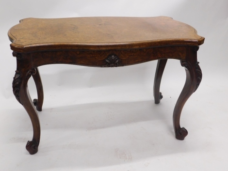 A large Victorian figured and burr walnut card table, the shaped top with a moulded edge enclosing a baize lined interior above a shaped frieze carved with leaves, on leaf carved cabriole legs, 72cm high, 106cm wide, 60cm deep.