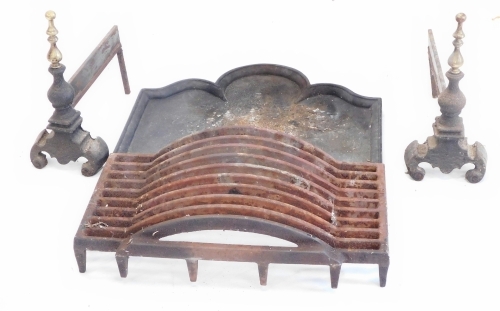 A cast iron and brass fire grate, with turned finials, with an associated grate and a fire back, with a moulded edge and arched centre, the fire back, 62cm wide.