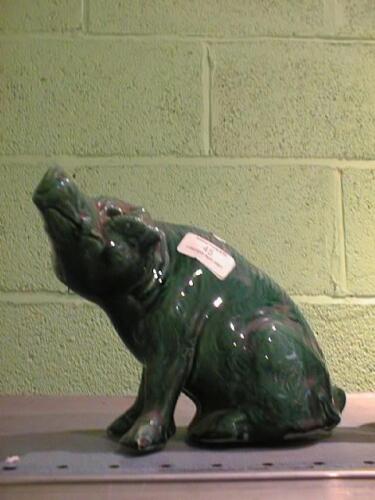 A green pottery pig, possibly Moores