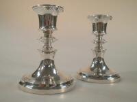 A pair of Edward VII silver boudoir candlesticks