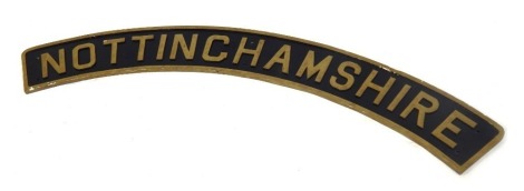 A replica Nottinghamshire locomotive name plate, of arched design, on a black border with gold letters, 135cm arched, 17cm high.