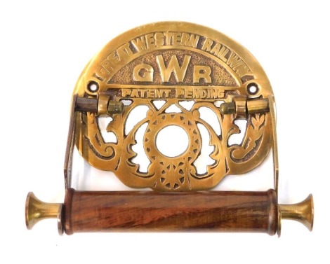 A Great Western Railway toilet roll holder, with cast brass back plate bearing title and GWR logo and a turned wooden holder, 19cm diameter.