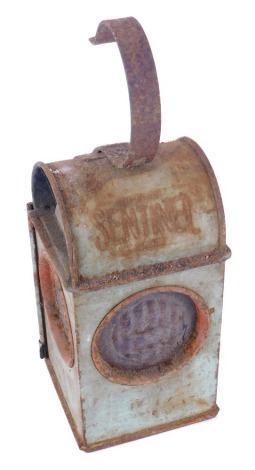 A Sentinel roadworks lantern, in metal casing with red mottled panes.