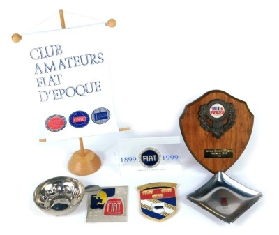 A collection of Fiat collectables, comprising a Fiat ashtray, a Fiat 1899-1999 paperweight, and a Club Amateurs d'Epoque banner. (3)