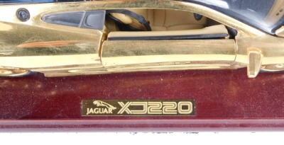 A Jaguar XJ 220 diecast model, in gold on a wooden plinth, in a fitted case. - 3