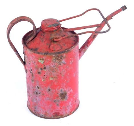 A red vintage oil can.