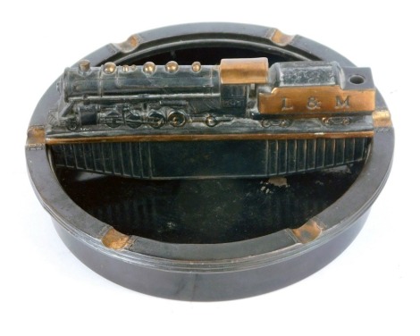 A Litchfield and Madison Railway tin and cast iron ashtray, modelled with an L & M locomotive, 23cm diameter.