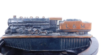 A Litchfield and Madison Railway tin and cast iron ashtray, modelled with an L & M locomotive, 23cm diameter. - 2