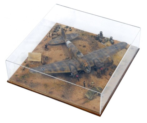 A 1:48 scale cased diorama model Heinkel HE III Bomber, North Africa 1942, 14cm high, 44cm wide, 44cm deep.