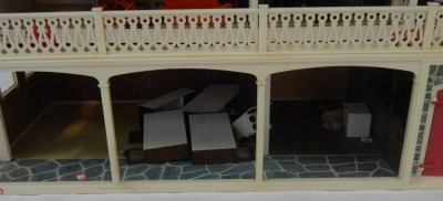 A Lundby doll's house, the house with a tiled roof, and glazed window panels with balcony and lower tier, with an open interior, and various plastic furniture, 64cm high, 92cm wide, 37cm deep. - 3