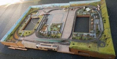 A N gauge substantial model railway layout, with buildings, trees, station platforms, etc., comprising of three sections. Measurements to follow.