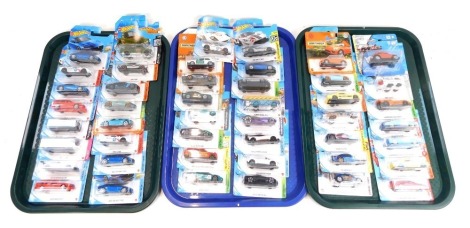 Matchbox, Hot Wheels and Maisto diecast vehicles, all in blister packs. (3 trays)