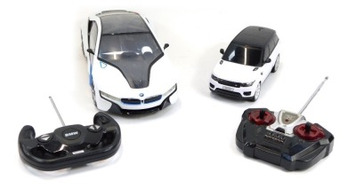 A Rastar remote controlled BMW I8, scale 1:14, together with a Gianfengyuan Toys Company Limited remote control model of a 2014 Range Rover Sport, both with controllers.