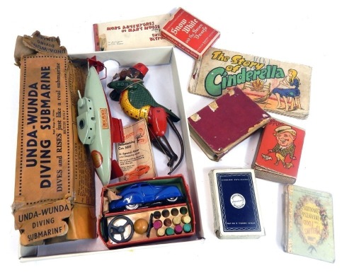 Tin plate toys and playing cards, a Schuco clockwork Telestring Car 3000, boxed, with instruction book, a small group of playing cards, The Story Book of Cinderella, a tin plate submarine and Lehmann monkey. (1 box)