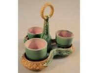 A Victorian majolica three cup trefoil egg cruet (AF)