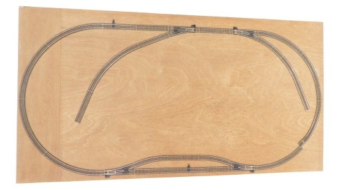 A railway layout, mounted on chipboard, with OO gauge track. 64cm x 86cm.