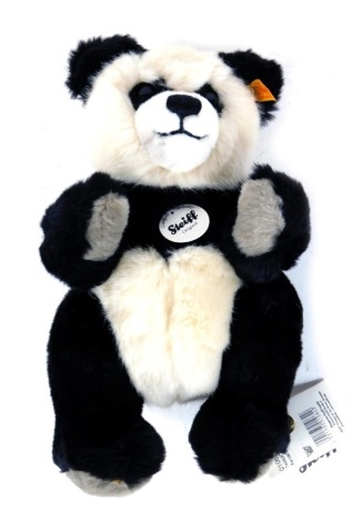 A Steiff panda, with tag and label to ear, 26cm high.