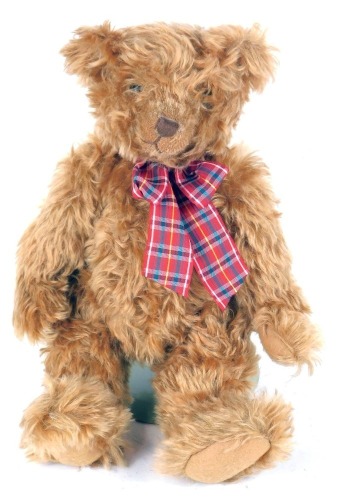 A Sunbid brown plush jointed Teddy bear, on stand, 39cm high.