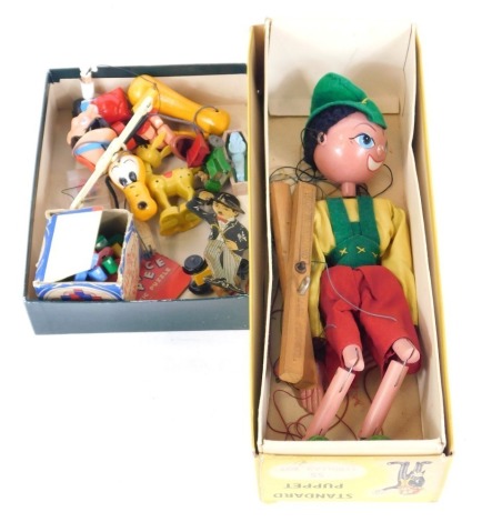 A small group of toys and games, comprising a Pelham puppet Pinocchio, boxed, Rubik' Cube, Pluto puppet, Pinocchio puppet, AA car, etc. (2 boxes)