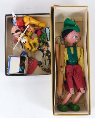 A small group of toys and games, comprising a Pelham puppet Pinocchio, boxed, Rubik' Cube, Pluto puppet, Pinocchio puppet, AA car, etc. (2 boxes) - 2