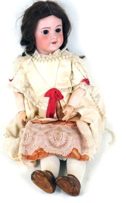 A French bisque headed doll, bearing stamp SFBJ, no.301 Paris, with closing eyes and articulated limbs, 55cm high.