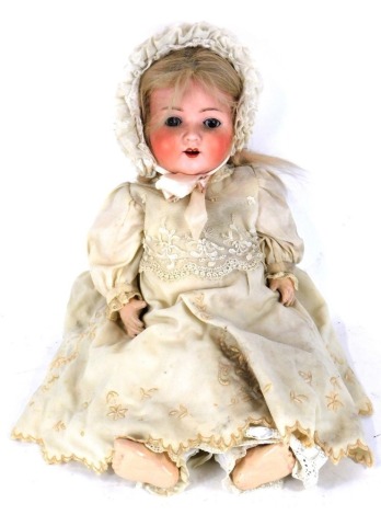 An Armand Marseille German bisque headed doll, no. 95A9M, with closing eyes and articulated limbs, 51cm high.