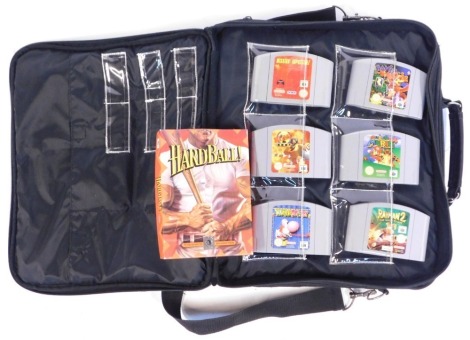 A Nintendo 64 games console, with single controller, and selection of games to include Golden Eye 007 Mission Impossible, Banjo Kazooi, Super Mario 64, Raymond II The Great Escapes, Yoshi's Story, Blast Corps, and Hardball, all in a Nintendo 64 carry case