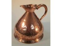 A large copper jug engraved A