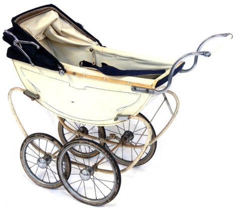 A Silver Cross style doll's pram, on a cream metal frame with a blue and cream interior, 81cm high, 100cm wide, 34cm deep.